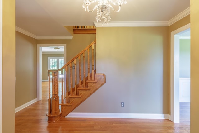 7900 Ooltewah Georgetown Rd, Ooltewah, TN 37363 - stairs featuring crown molding, wood finished floors, a chandelier, and baseboards