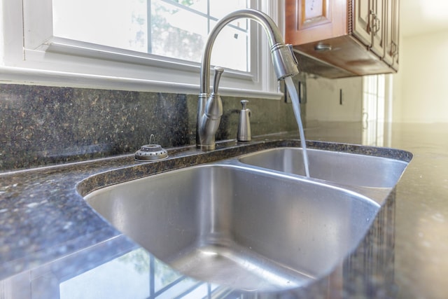 7900 Ooltewah Georgetown Rd, Ooltewah, TN 37363 - kitchen view of a sink, tasteful backsplash, dark stone countertops, and brown cabinets