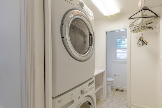 7900 Ooltewah Georgetown Rd, Ooltewah, TN 37363 - washroom with stacked washer / drying machine, light tile patterned floors, and baseboards