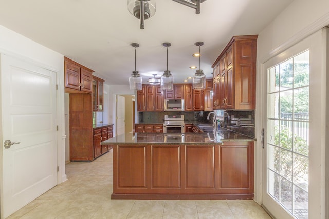 7900 Ooltewah Georgetown Rd, Ooltewah, TN 37363 - kitchen with stainless steel appliances, a peninsula, tasteful backsplash, dark stone countertops, and a sink