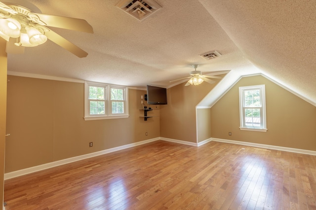 7900 Ooltewah Georgetown Rd, Ooltewah, TN 37363 - additional living space with a ceiling fan, plenty of natural light, light wood-style floors, a textured ceiling, and baseboards