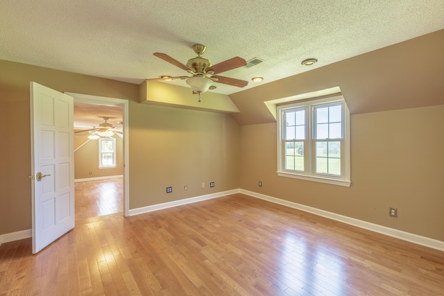 7900 Ooltewah Georgetown Rd, Ooltewah, TN 37363 - bonus room featuring ceiling fan, light wood-style floors, a textured ceiling, baseboards, and lofted ceiling