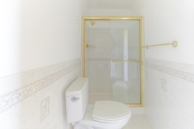 7900 Ooltewah Georgetown Rd, Ooltewah, TN 37363 - full bathroom featuring tile walls, toilet, a stall shower, and a wainscoted wall