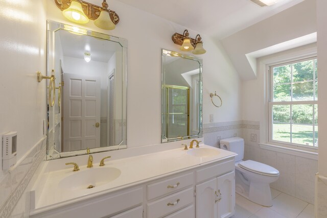 7900 Ooltewah Georgetown Rd, Ooltewah, TN 37363 - full bath with healthy amount of natural light, toilet, double vanity, tile walls, and wainscoting