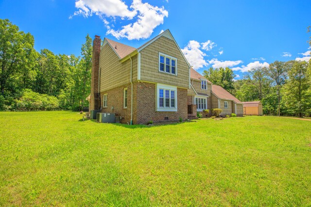 7900 Ooltewah Georgetown Rd, Ooltewah, TN 37363 - rear view of house with brick siding, a yard, central AC unit, and a chimney