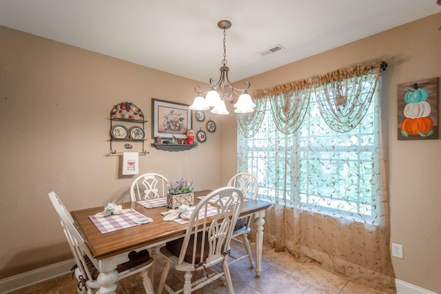 169 Southern Dr, Ringgold, GA 30736 - dining area featuring a chandelier, light tile patterned floors, and baseboards