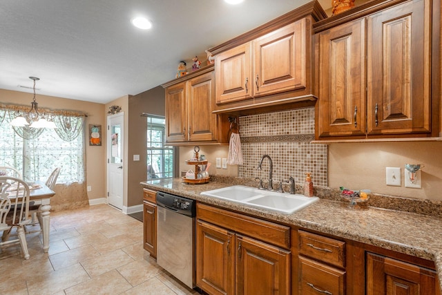 169 Southern Dr, Ringgold, GA 30736 - kitchen featuring stainless steel dishwasher, a sink, a chandelier, brown cabinetry, and baseboards