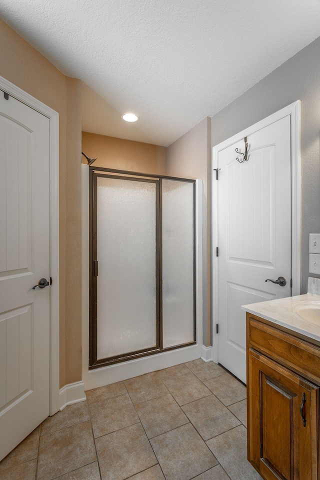 169 Southern Dr, Ringgold, GA 30736 - full bathroom with a shower stall, vanity, tile patterned flooring, recessed lighting, and a textured ceiling