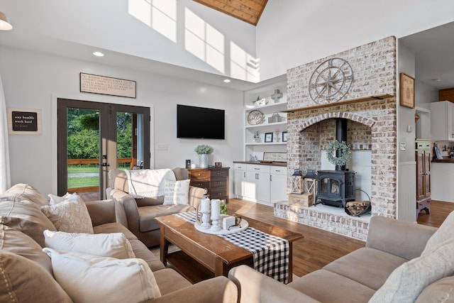 229 Blue Bird Way, Dunlap, TN 37327 - living room featuring light wood-style floors, built in features, a wood stove, high vaulted ceiling, and recessed lighting