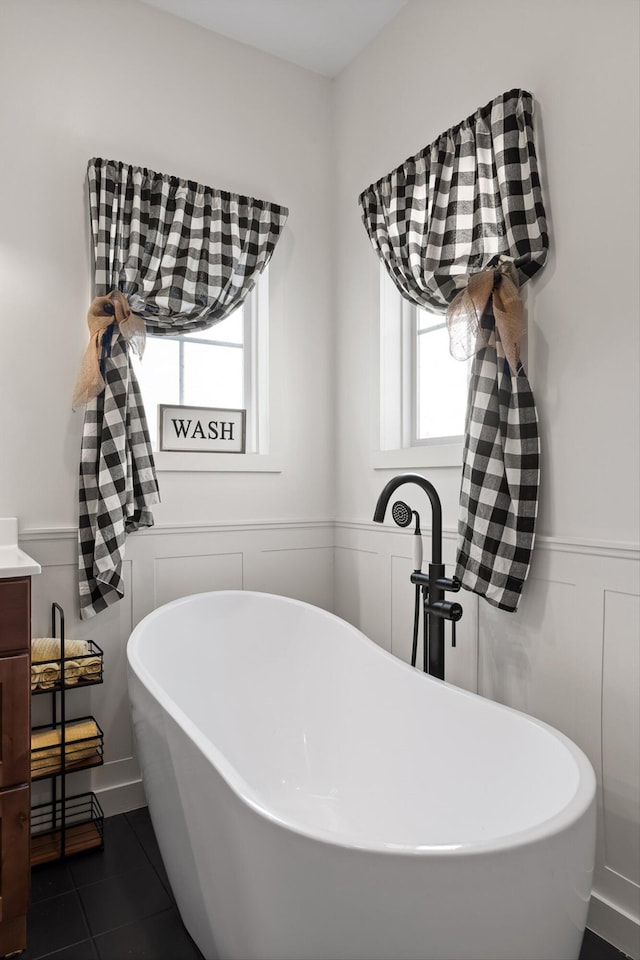 229 Blue Bird Way, Dunlap, TN 37327 - bathroom with healthy amount of natural light, a freestanding bath, a wainscoted wall, tile patterned floors, and vanity