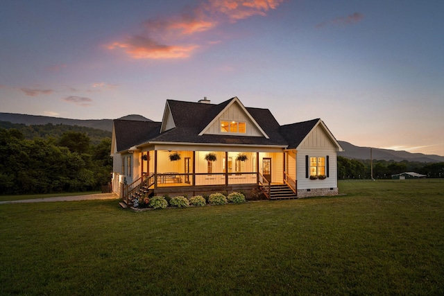 229 Blue Bird Way, Dunlap, TN 37327 - back of property at dusk with crawl space, board and batten siding, a lawn, covered porch, and a chimney