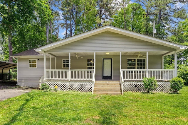 724 Shelly Ln, Rossville, GA 30741 - view of front of property featuring covered porch, a ceiling fan, a front lawn, a detached carport, and roof with shingles