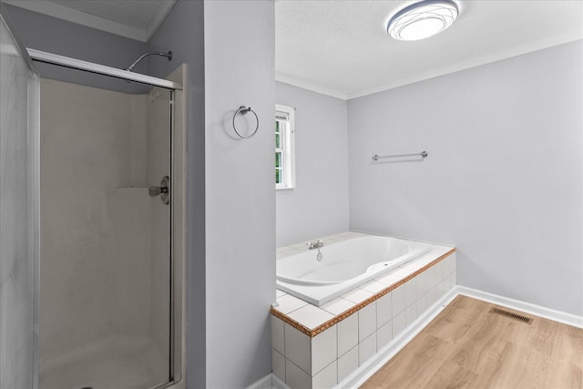 724 Shelly Ln, Rossville, GA 30741 - full bathroom featuring a shower stall, a bath, wood finished floors, crown molding, and baseboards