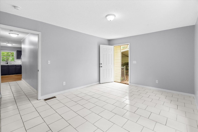 724 Shelly Ln, Rossville, GA 30741 - spare room with a sink, a smoke detector, baseboards, and light tile patterned floors
