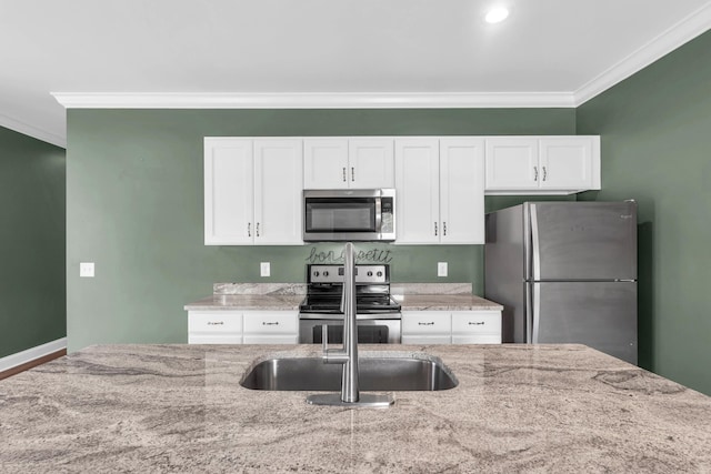 603 Browns Ferry Rd, Chattanooga, TN 37419 - kitchen featuring appliances with stainless steel finishes, ornamental molding, white cabinets, and light stone countertops