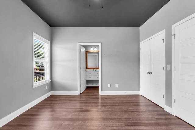 603 Browns Ferry Rd, Chattanooga, TN 37419 - unfurnished bedroom with wood finished floors, baseboards, connected bathroom, and a closet