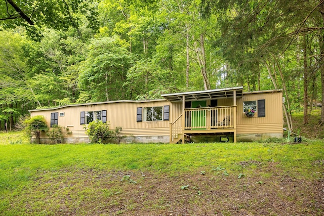 5203 Howardsville Rd, Apison, TN 37302 - manufactured / mobile home with crawl space, a wooded view, and a front yard