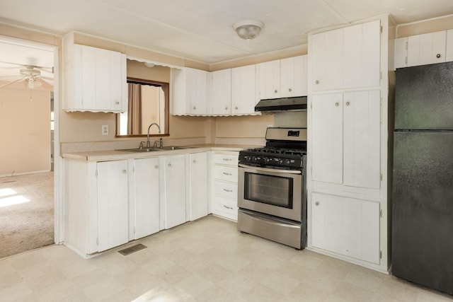 5203 Howardsville Rd, Apison, TN 37302 - kitchen featuring freestanding refrigerator, gas stove, a sink, under cabinet range hood, and light countertops