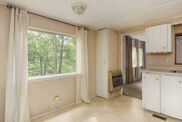 5203 Howardsville Rd, Apison, TN 37302 - kitchen with heating unit, light countertops, light floors, and white cabinets