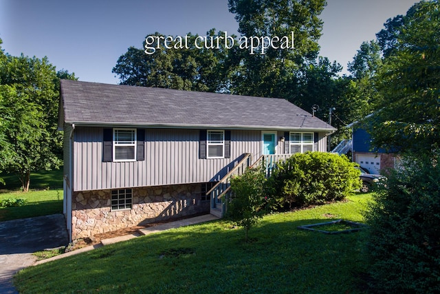 7115 Elmbrook Ln, Harrison, TN 37341 - view of front facade with a front yard, stone siding, and roof with shingles