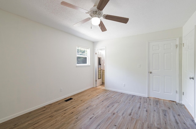 7115 Elmbrook Ln, Harrison, TN 37341 - unfurnished bedroom featuring light wood finished floors, a textured ceiling, ceiling fan, and ensuite bath