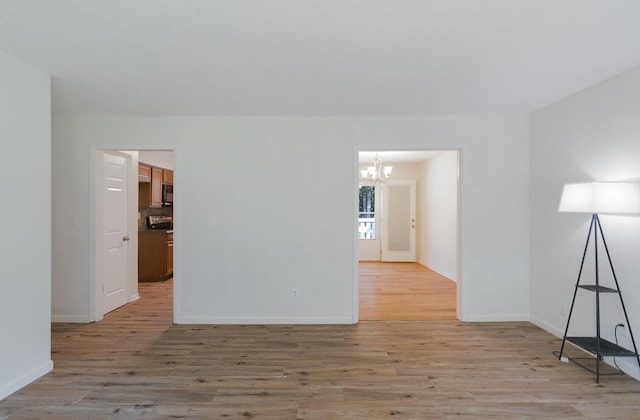7115 Elmbrook Ln, Harrison, TN 37341 - empty room featuring a chandelier and light wood finished floors