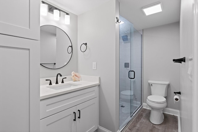 2904 Reflection Ln, Ooltewah, TN 37363 - full bath with toilet, wood finished floors, vanity, a shower stall, and baseboards