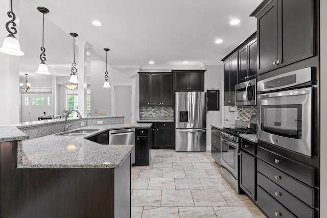 2904 Reflection Ln, Ooltewah, TN 37363 - kitchen featuring appliances with stainless steel finishes, a sink, crown molding, backsplash, and light stone counters