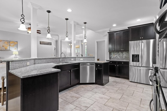 2904 Reflection Ln, Ooltewah, TN 37363 - kitchen featuring stainless steel appliances, a sink, crown molding, decorative backsplash, and light stone countertops