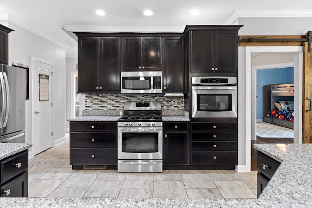 2904 Reflection Ln, Ooltewah, TN 37363 - kitchen with stainless steel appliances, crown molding, light stone counters, a barn door, and recessed lighting