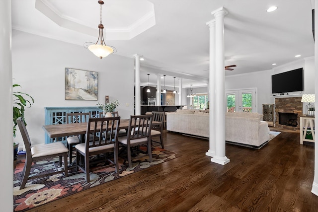 2904 Reflection Ln, Ooltewah, TN 37363 - dining space featuring crown molding, a stone fireplace, ornate columns, dark wood-type flooring, and recessed lighting