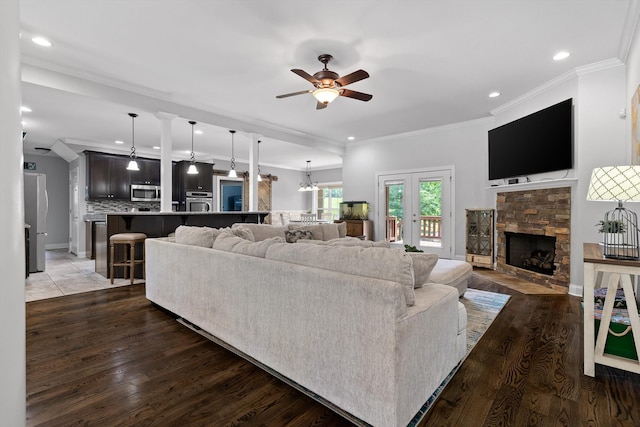 2904 Reflection Ln, Ooltewah, TN 37363 - living room featuring ceiling fan, recessed lighting, a fireplace, wood finished floors, and crown molding