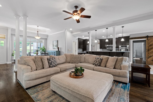 2904 Reflection Ln, Ooltewah, TN 37363 - living room featuring ornamental molding, a ceiling fan, dark wood-type flooring, decorative columns, and a barn door
