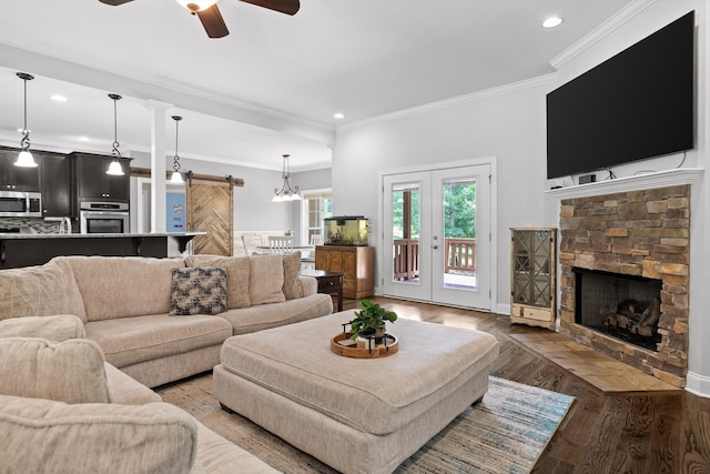 2904 Reflection Ln, Ooltewah, TN 37363 - living room with a barn door, a ceiling fan, a fireplace, wood finished floors, and recessed lighting