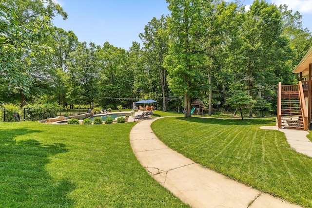 2904 Reflection Ln, Ooltewah, TN 37363 - view of green lawn with stairs, an outdoor pool, and view of wooded area