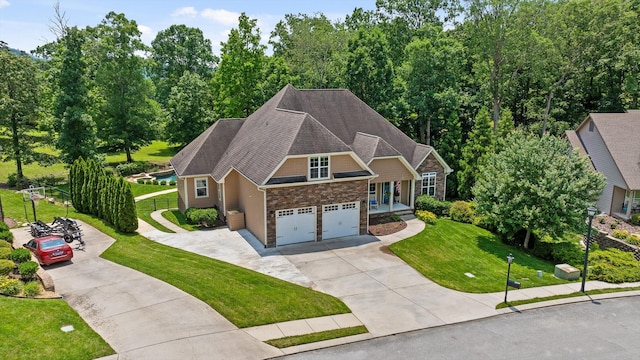 2904 Reflection Ln, Ooltewah, TN 37363 - view of front of property with driveway, stone siding, a front lawn, and a shingled roof