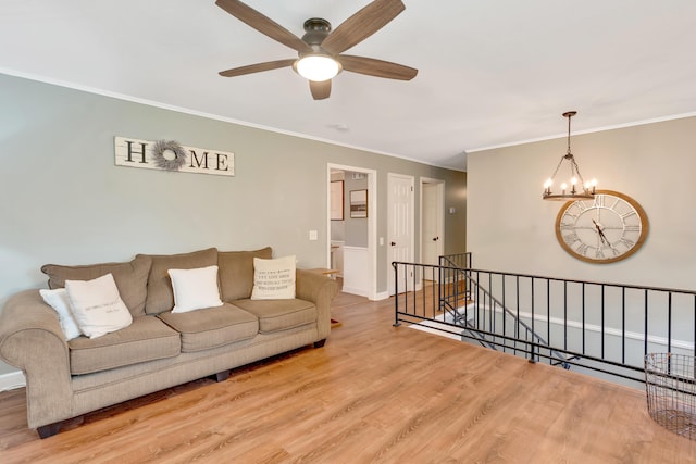1415 Caramel Cir, Hixson, TN 37343 - living area featuring a ceiling fan, wood finished floors, ornamental molding, a chandelier, and baseboards