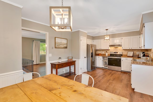 1415 Caramel Cir, Hixson, TN 37343 - kitchen featuring appliances with stainless steel finishes, a sink, white cabinets, wood finished floors, and wainscoting