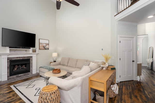 3773 Lacy Leaf Ln, Apison, TN 37302 - living room featuring a high ceiling, a ceiling fan, wood finished floors, a tiled fireplace, and baseboards
