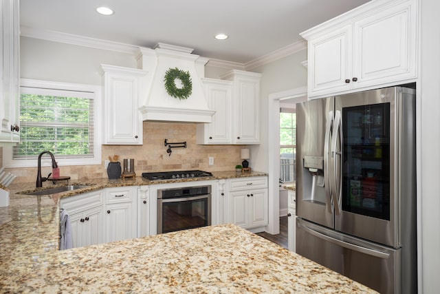 3773 Lacy Leaf Ln, Apison, TN 37302 - kitchen with stainless steel appliances, a sink, white cabinetry, ornamental molding, and light stone countertops