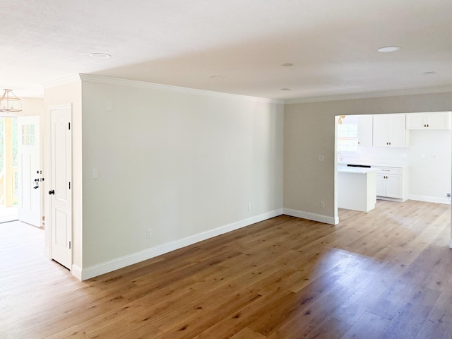 6527 Shallowmar Ln, Hixson, TN 37343 - unfurnished living room with ornamental molding, light wood-style flooring, baseboards, and a chandelier