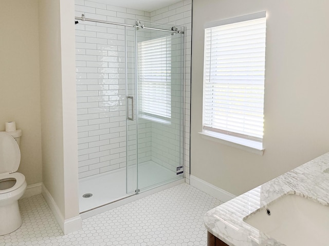 6527 Shallowmar Ln, Hixson, TN 37343 - bathroom featuring a shower stall, toilet, double vanity, and tile patterned floors