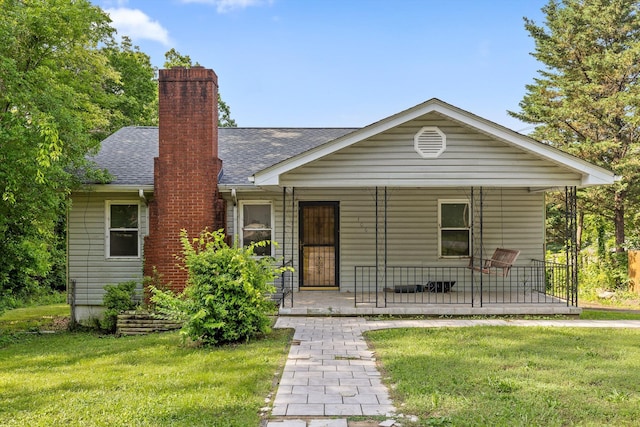 306 Pine Ridge Rd, Chattanooga, TN 37405 - view of front of home with covered porch, a front yard, roof with shingles, and a chimney