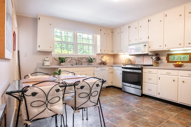 504 Fleetwood Dr, Lookout Mountain, TN 37350 - kitchen featuring white appliances, decorative backsplash, light countertops, dark stone finish flooring, and ornamental molding