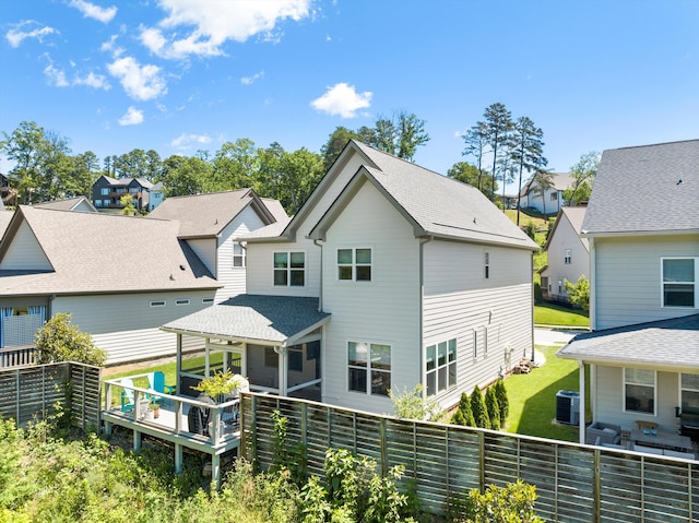 1355 Carrington Way, Chattanooga, TN 37405 - back of property featuring a residential view, central air condition unit, a sunroom, roof with shingles, and a wooden deck