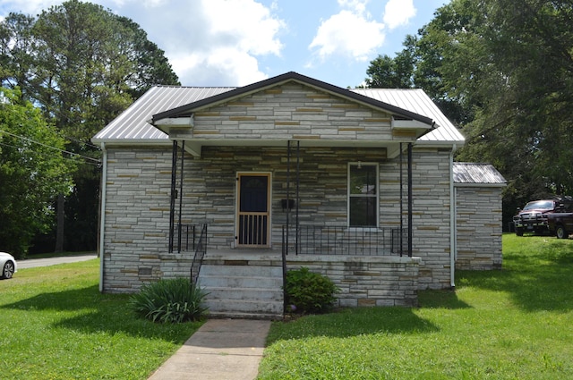 912 N Price St, Sweetwater, TN 37874 - view of front of property with stone siding, a porch, a front yard, and metal roof