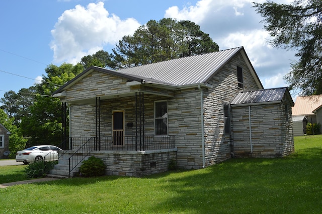 912 N Price St, Sweetwater, TN 37874 - view of side of home featuring stone siding, a porch, a yard, and metal roof