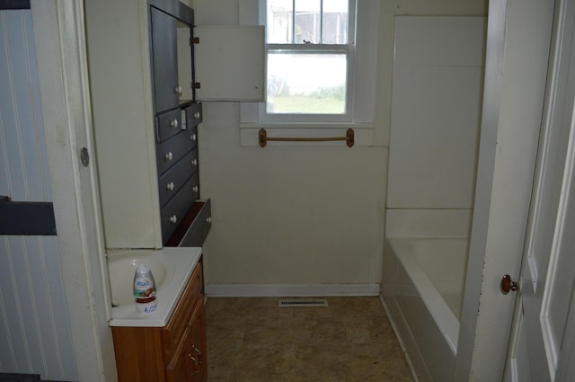 912 N Price St, Sweetwater, TN 37874 - bathroom with vanity, a bath, and baseboards