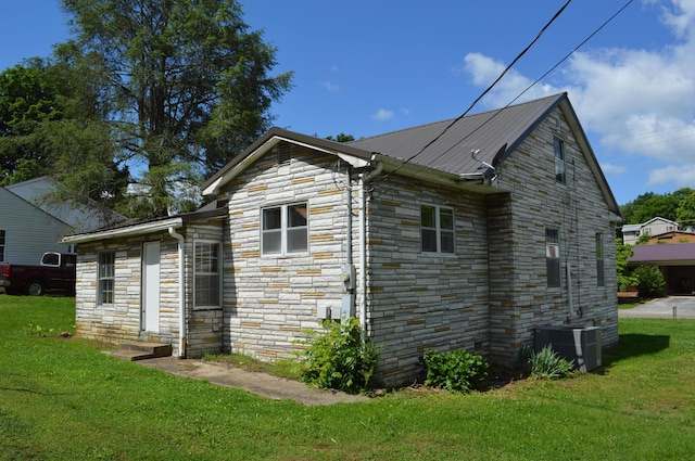 912 N Price St, Sweetwater, TN 37874 - view of property exterior with stone siding, central AC unit, and a lawn