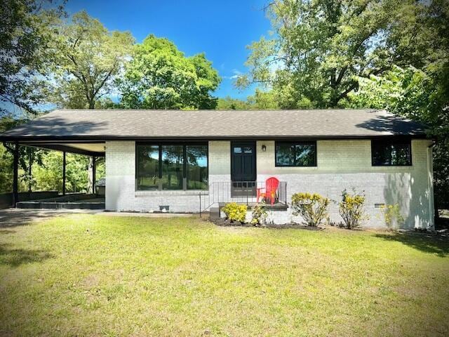 7015 Gamble Rd, Birchwood, TN 37308 - view of front of house with brick siding, a front yard, an attached carport, and a shingled roof